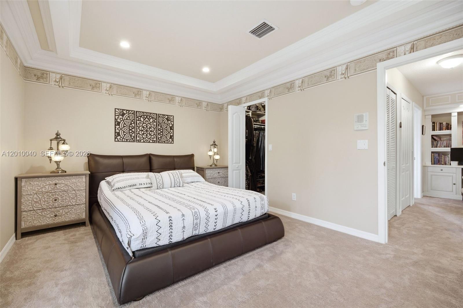 12978 Southwest 29th Court Miramar, FL 33027 - Photo 20 of 32 a bedroom with a large bed and dresser