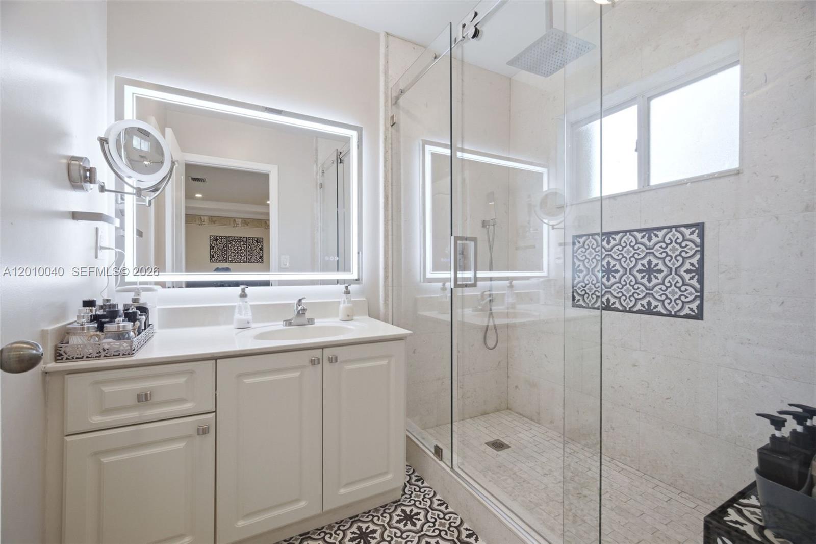 12978 Southwest 29th Court Miramar, FL 33027 - Photo 23 of 32 a bathroom with a shower sink and mirror