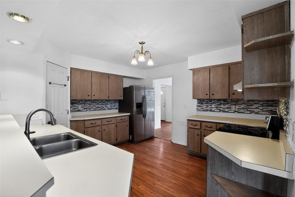 4553 Southeast 14th Street Ocala, FL 34471 - Photo 12 of 28 a kitchen with a refrigerator stove and sink