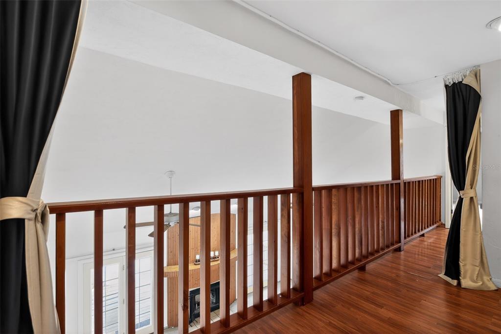 4553 Southeast 14th Street Ocala, FL 34471 - Photo 16 of 28 a view of hallway with wooden floor and stairs