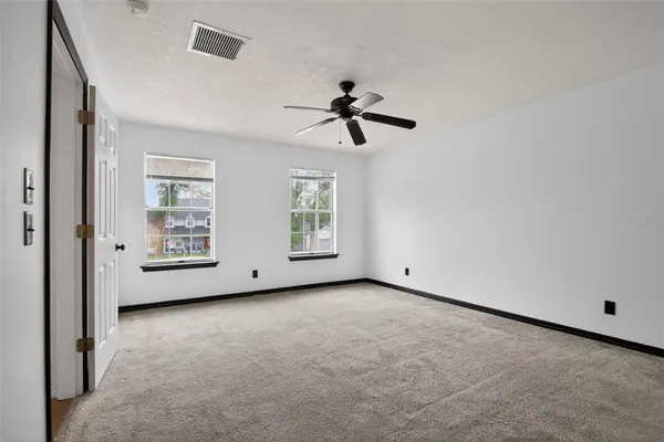 a view of an empty room with windows