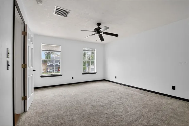 a view of an empty room with windows