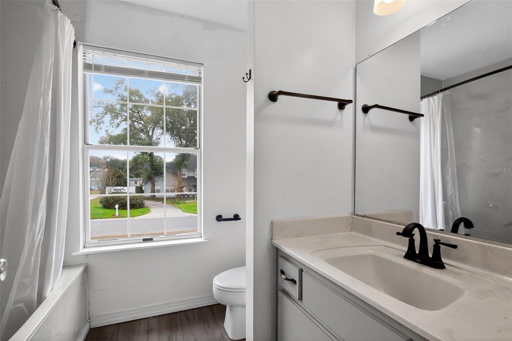 4553 Southeast 14th Street Ocala, FL 34471 - Photo 19 of 28 a bathroom with a sink and a large mirror