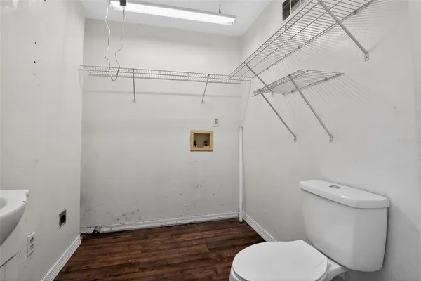 a white toilet sitting next to a shower