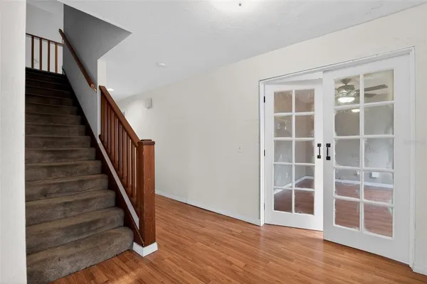 a view of entryway with wooden floor and stairs
