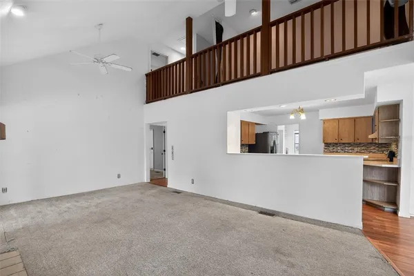 a view of kitchen with microwave and cabinets