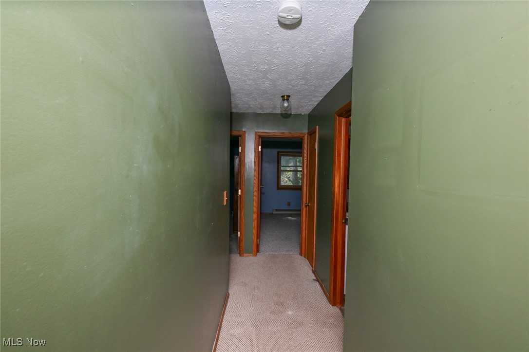 3079 Stroup Road Atwater, OH 44201 - Photo 30 of 40 Welcome to 3079 Stroup Rd, Atwater, OH 44201-9105 - The main level hallway looking towards the bedrooms.
