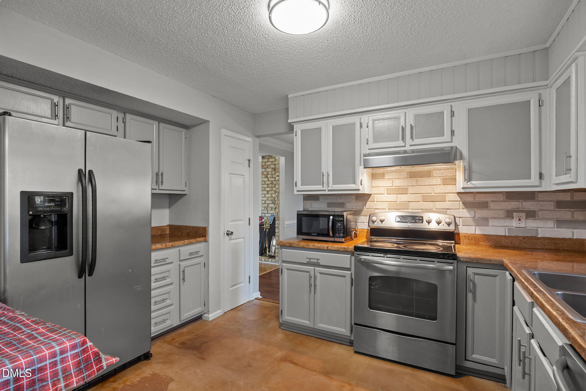 4700 Tolley Court Raleigh, NC 27616 - Photo 19 of 38 a kitchen with stainless steel appliances a stove sink and refrigerator
