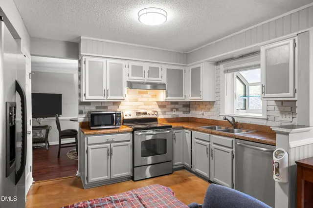 a kitchen with a sink stove and cabinets