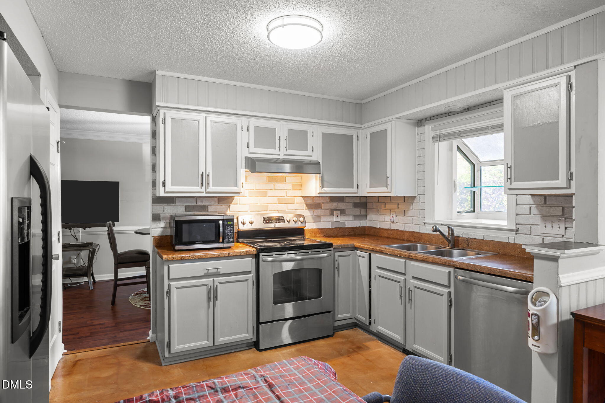 4700 Tolley Court Raleigh, NC 27616 - Photo 21 of 38 a kitchen with a sink stove and cabinets