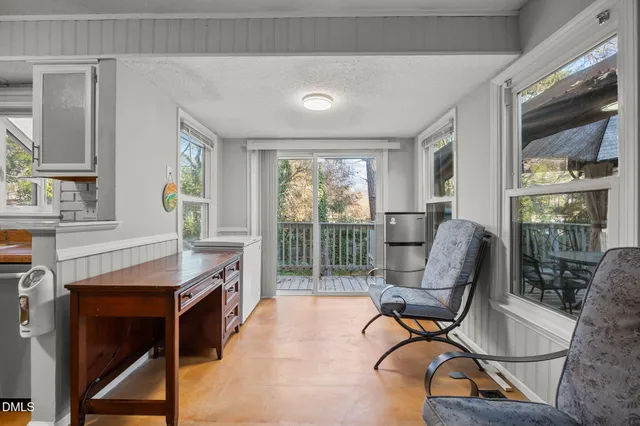 a work room with furniture and a floor to ceiling window