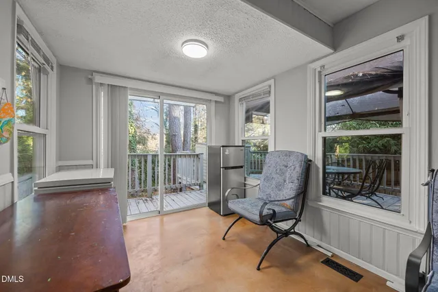 a living room with furniture and a floor to ceiling window