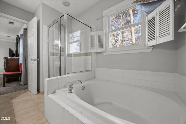 a bathroom with a bathtub and a shower