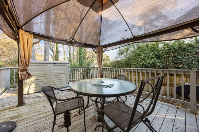 a view of a chairs and table in the balcony