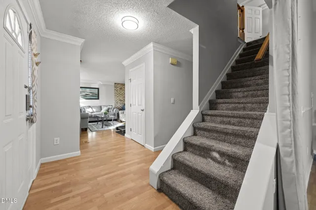 a view of entryway and hall with wooden floor