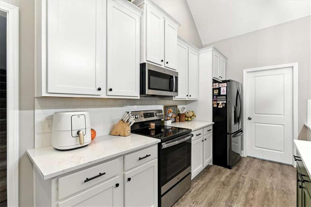 62 Joe Rowell Road Buchanan, GA 30113 - Photo 19 of 63 a kitchen with stainless steel appliances granite countertop a refrigerator sink and stove
