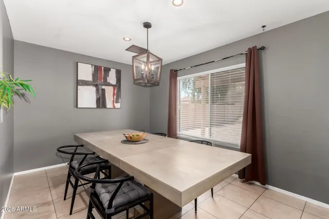 a view of a dining room with a table and chairs