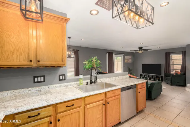 a kitchen with stainless steel appliances granite countertop a sink a stove and cabinets