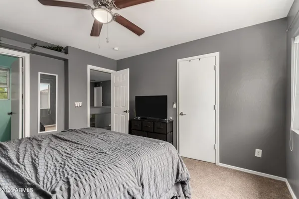a bedroom with a bed and a chandelier