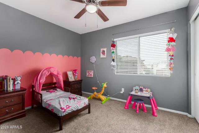 a bedroom with furniture and a window