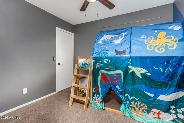 a utility room with toys and a painting on the wall