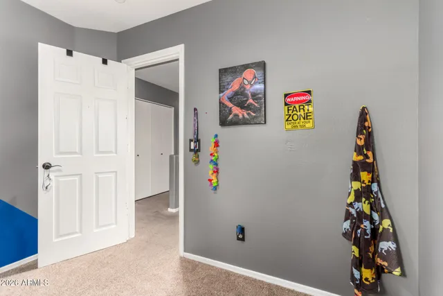 view of a hallway with paintings on the wall