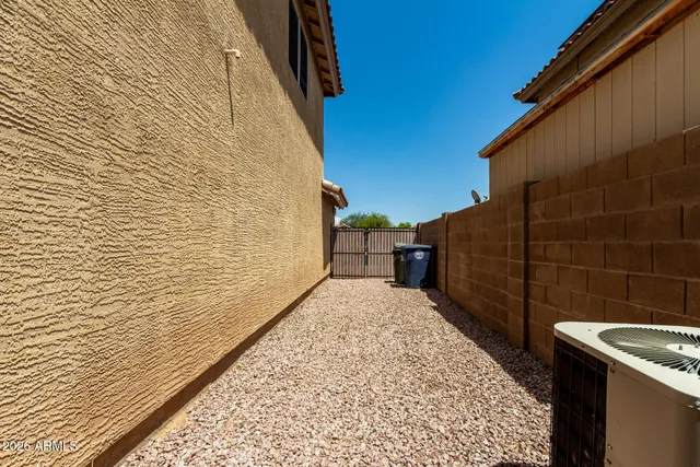 a view of a backyard with wooden fence