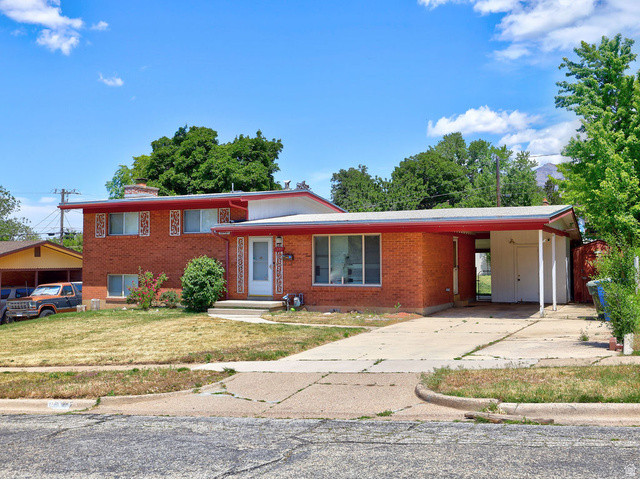1272 Cook Street Ogden, UT 84404 - Photo 44 of 46 Brick exterior with a red trim roofline, white front door, and an attached carport