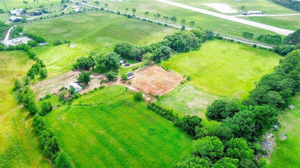 an aerial view of residential houses with outdoor space and street view