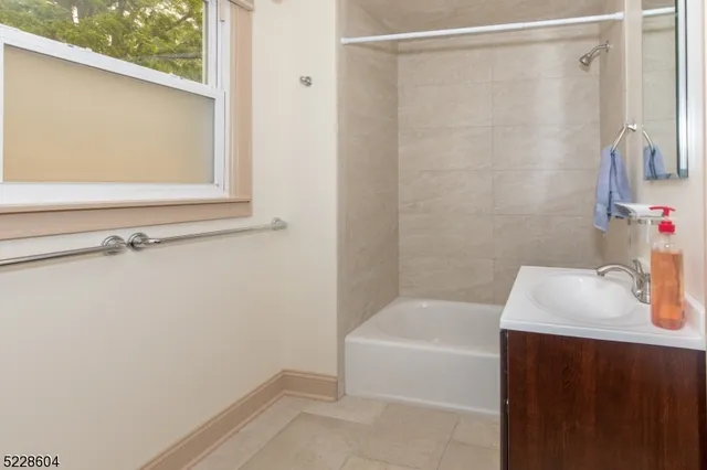 a bathroom with a bathtub and a sink