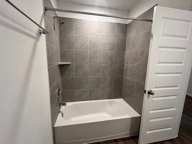 a bathroom with a bathtub and a shower
