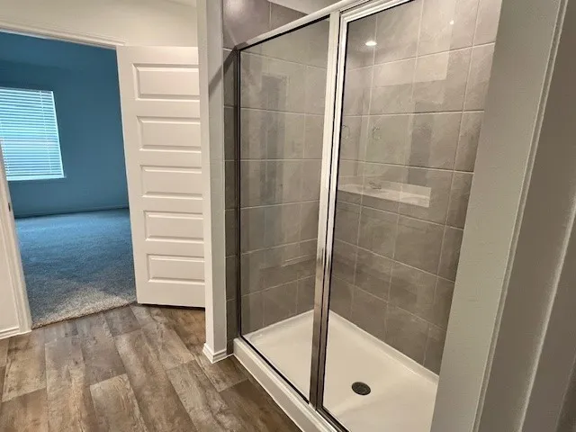a bathroom with a glass shower door
