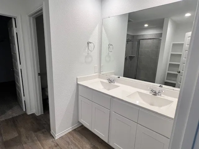 a bathroom with a double vanity sink and mirror