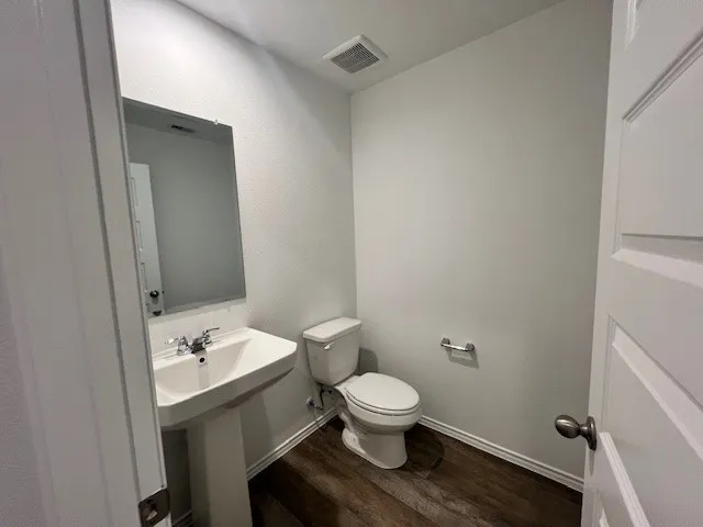 a white toilet sitting next to a bathroom sink