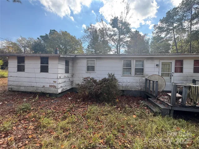 a backyard of a house with yard and outdoor seating