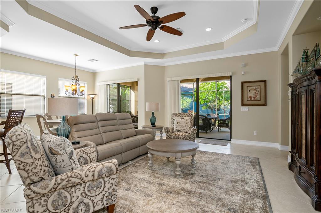 1349 Serrano Circle Naples, FL 34105 - Photo 12 of 37 a living room with furniture and a large window