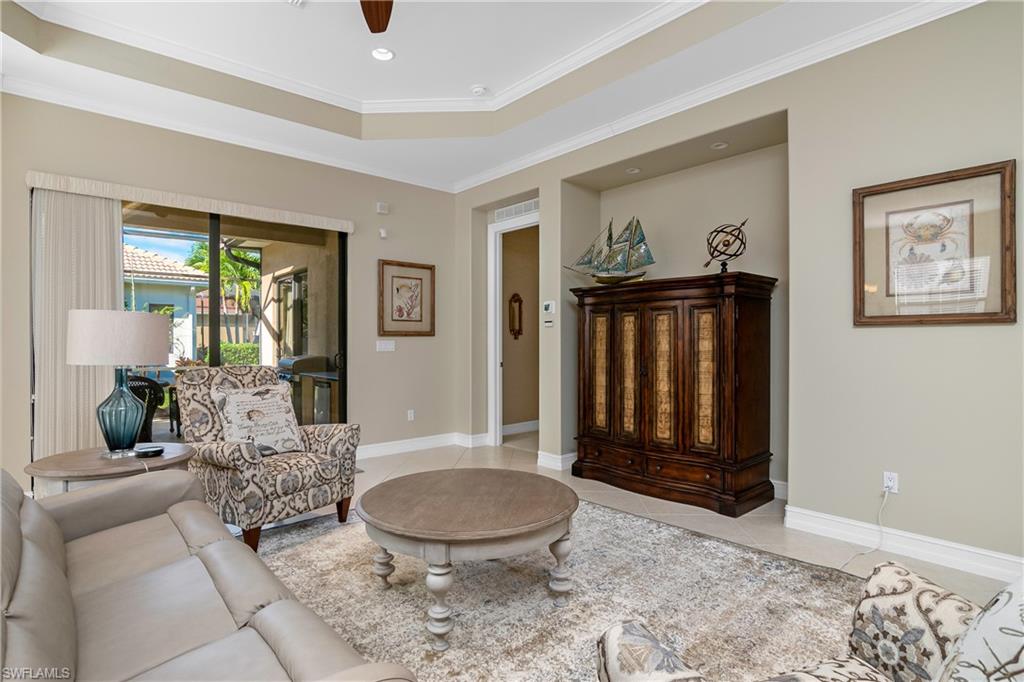 1349 Serrano Circle Naples, FL 34105 - Photo 13 of 37 a living room with furniture a window and a rug