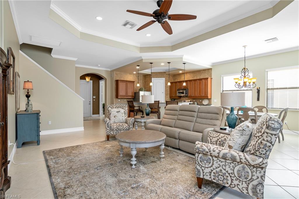 1349 Serrano Circle Naples, FL 34105 - Photo 14 of 37 a living room with furniture kitchen view and a chandelier
