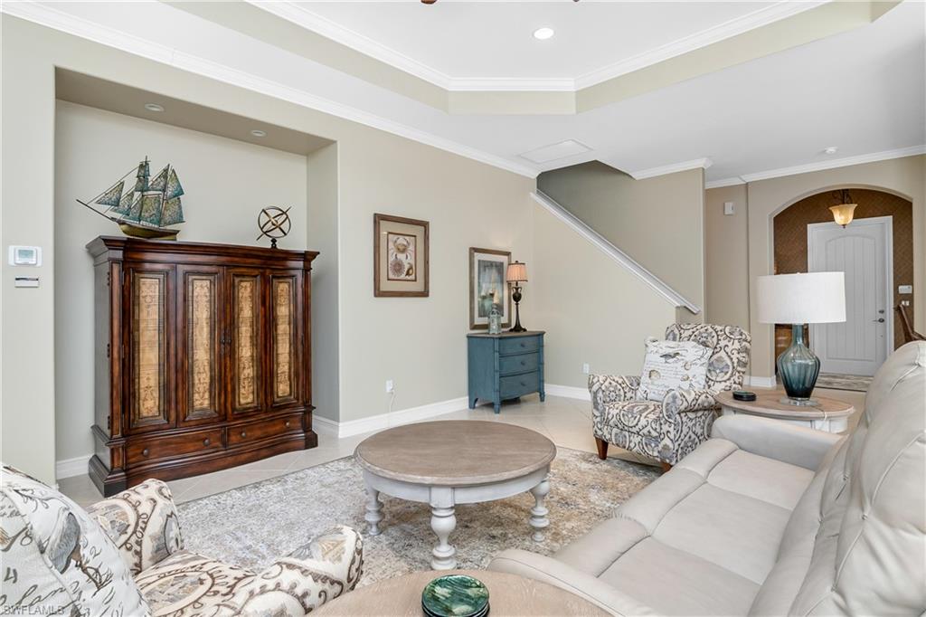 1349 Serrano Circle Naples, FL 34105 - Photo 15 of 37 a living room with furniture and a painting on the wall
