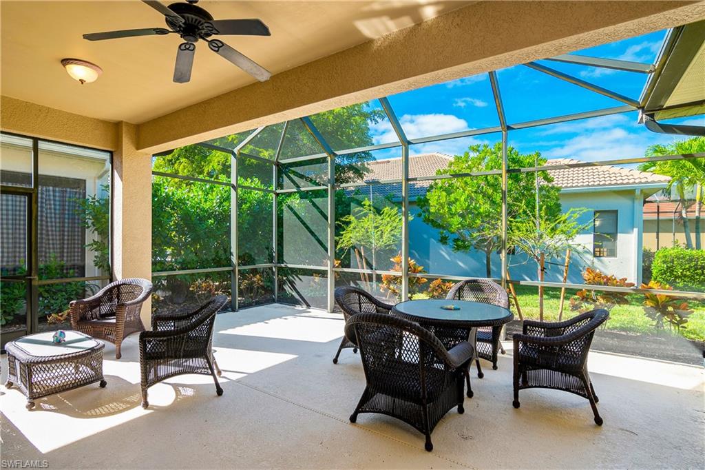 1349 Serrano Circle Naples, FL 34105 - Photo 24 of 37 a backyard of a house with table and chairs