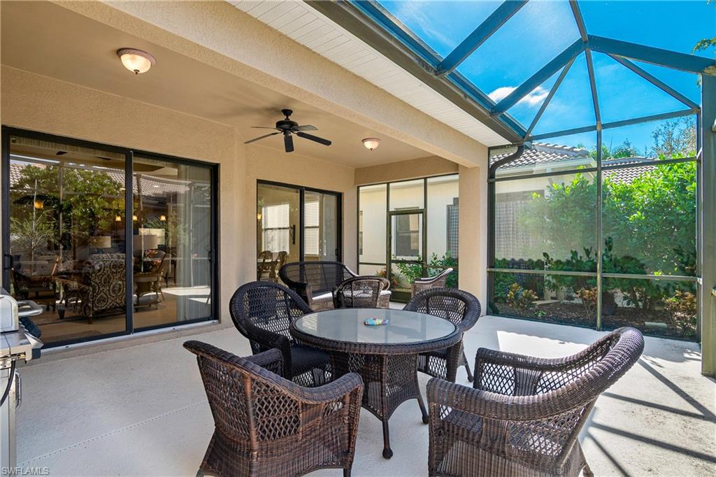 1349 Serrano Circle Naples, FL 34105 - Photo 25 of 37 a outdoor dining space with furniture and umbrella