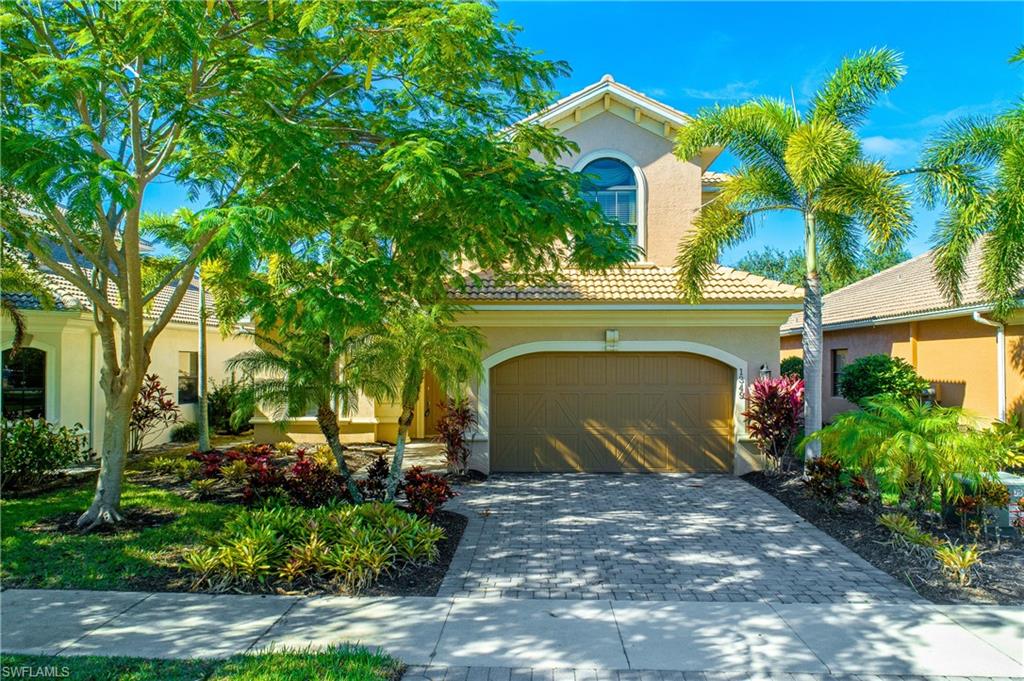 1349 Serrano Circle Naples, FL 34105 - Photo 28 of 37 a front view of a house with a garden