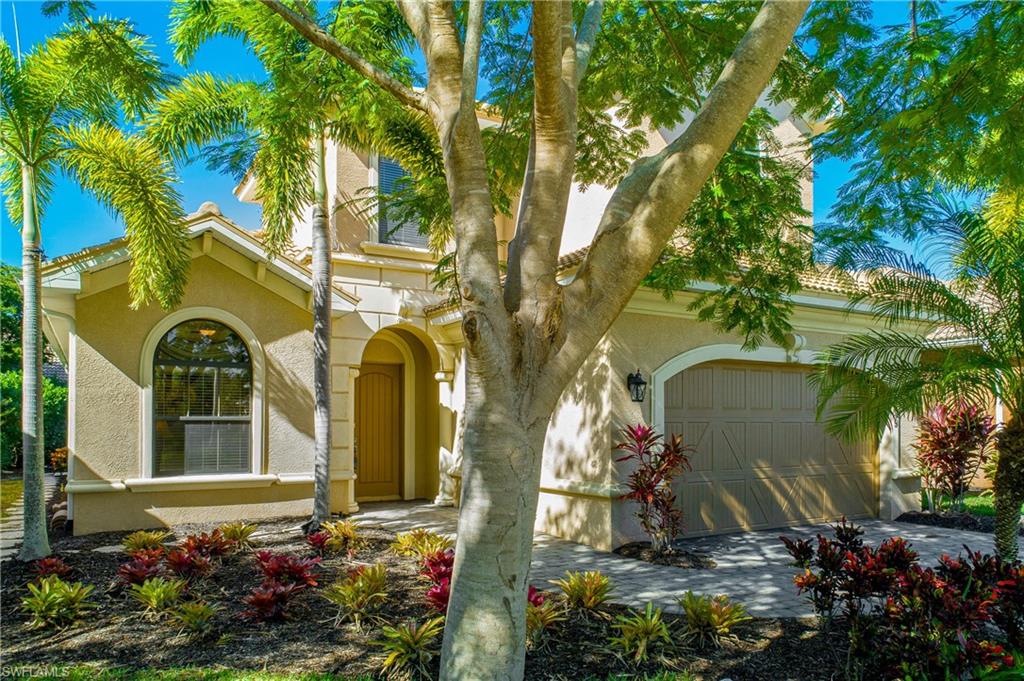 1349 Serrano Circle Naples, FL 34105 - Photo 29 of 37 a couple of flower plants in front of a house