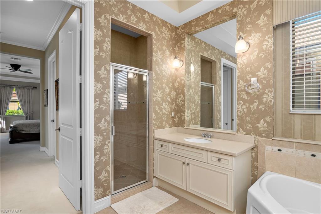 1349 Serrano Circle Naples, FL 34105 - Photo 5 of 37 a bathroom with a sink a toilet and shower