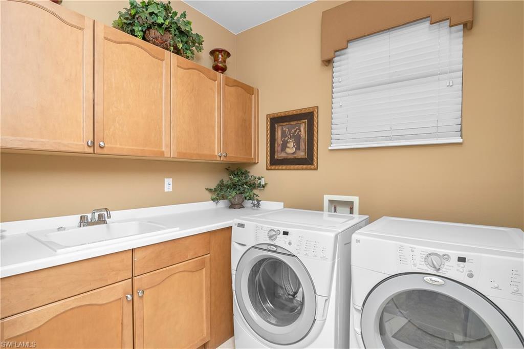 1349 Serrano Circle Naples, FL 34105 - Photo 7 of 37 a utility room with dryer and washer