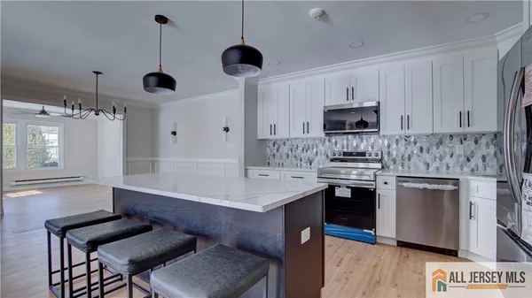 a kitchen with stainless steel appliances a stove refrigerator sink and cabinets