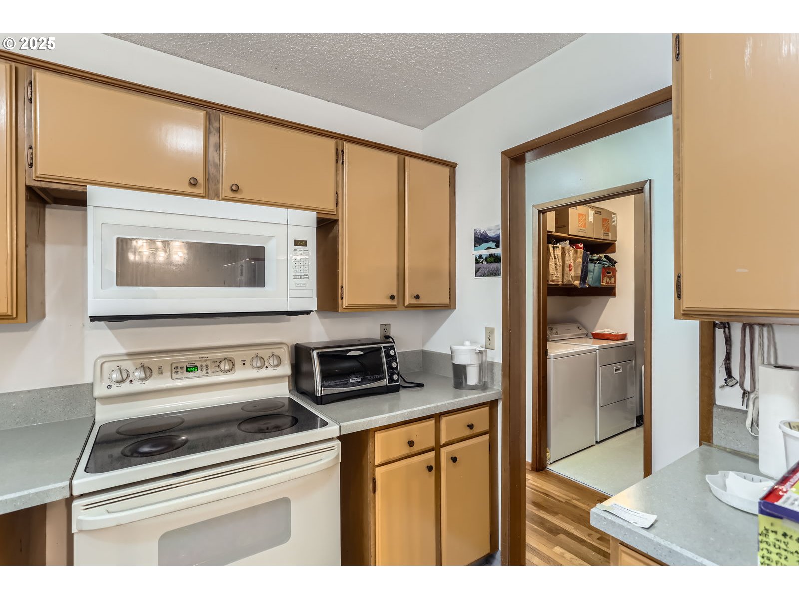 12330 Southeast Main Street Portland, OR 97233 - Photo 14 of 28 a kitchen with a stove a sink and a microwave