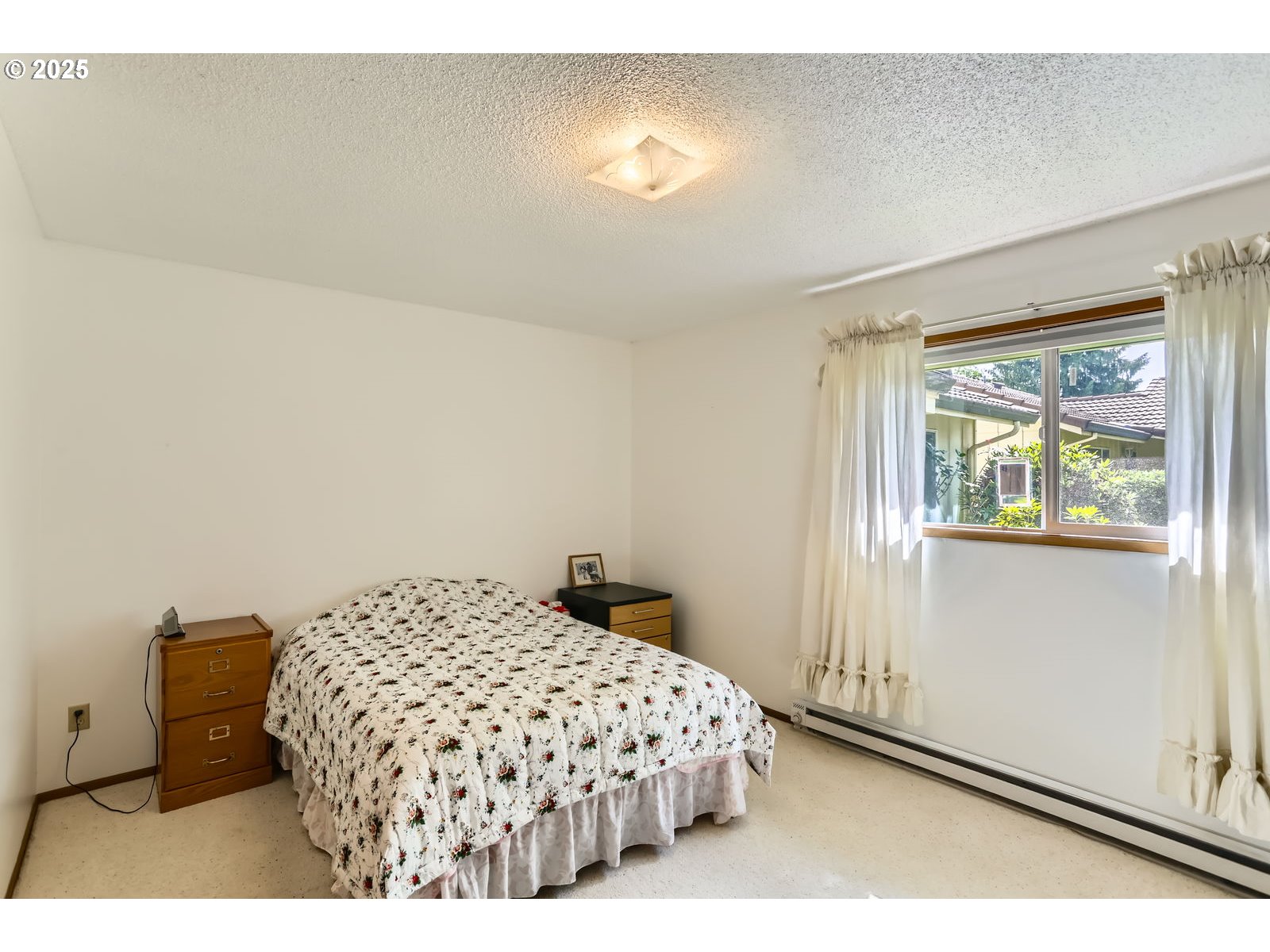 12330 Southeast Main Street Portland, OR 97233 - Photo 15 of 28 a bedroom with a bed and window