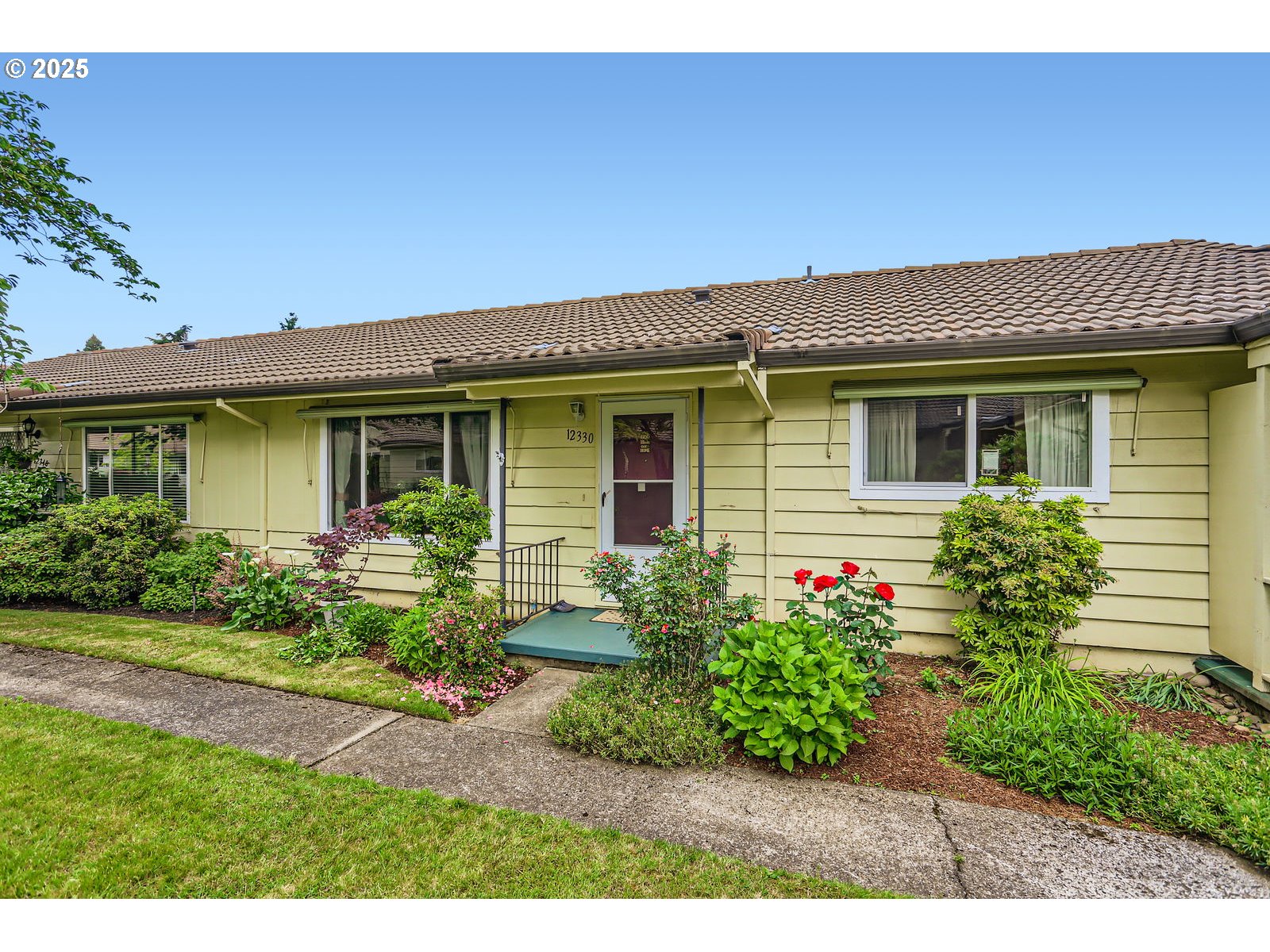 12330 Southeast Main Street Portland, OR 97233 - Photo 2 of 28 a front view of a house with a garden