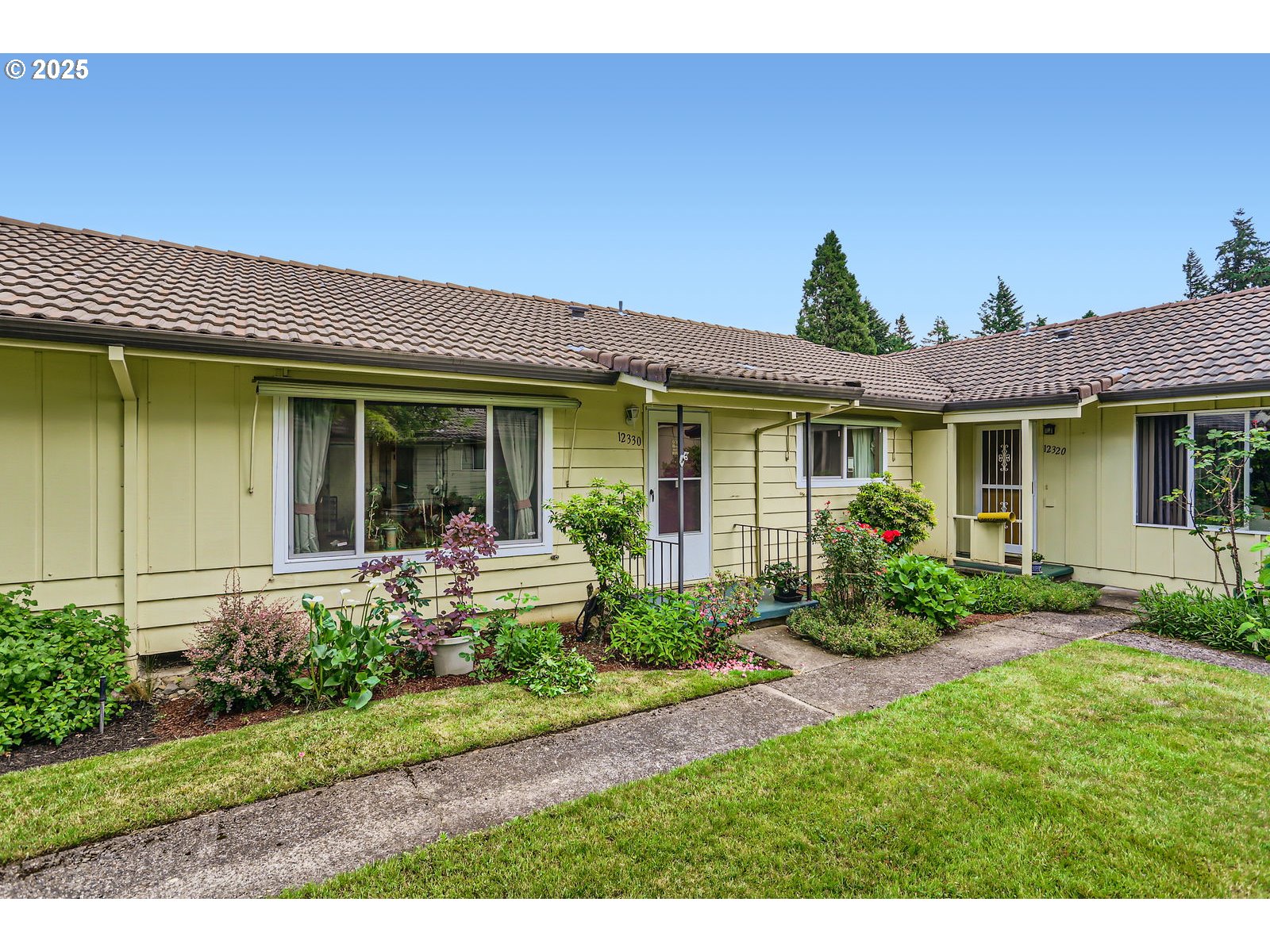 12330 Southeast Main Street Portland, OR 97233 - Photo 3 of 28 a front view of a house with garden